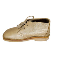 Side profile of a gold leather Duckfeet Helsingor boot with two-eyelet lacing and flat pale sole